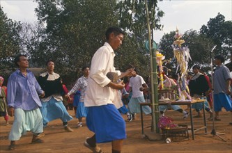 THAILAND, Chiang Rai Province, Huai Khrai, Lisu people dancing around New Year tree to a banjo