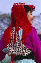 THAILAND, Chiang Rai Province, Doi Lan, Back view of a young Lisu woman wearing her New Year finery
