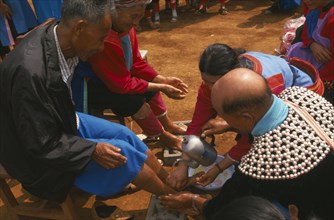 THAILAND, Chiang Rai Province, Huai Khrai, New Year. Lisu people paying respects to their elders by