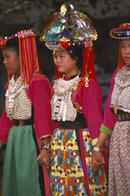 THAILAND, Chiang Rai Province, Huai Khrai, Young Lisu women in their New Year finery dancing