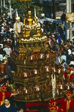 THAILAND, Chiang Mai, Songkran aka Thai New Year. Buddha image in lustration parade near Wat Phra