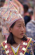 THAILAND, Chiang Mai, Hmong New Year. Portrait of a young Hmong woman in her New Year finery