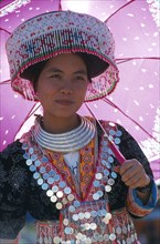 THAILAND, Chiang Mai, Hmong New Year. Young white Hmong woman in her New Year finery