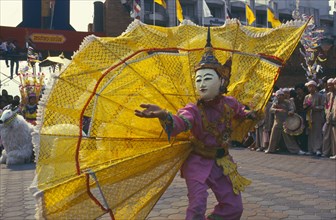 THAILAND, Chiang Mai, Shan Poi San Long. Crystal Children ceremony dancer with large yellow fan