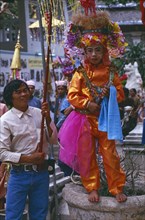 THAILAND, Chiang Mai, Shan Poi San Long. Crystal Children ceremony with Luk Kaeo in orange costume