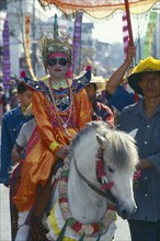 THAILAND, Chiang Mai, Shan Poi San Long. Crystal Children ceremony with child in costume riding a