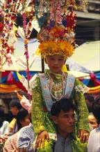 THAILAND, Chiang Mai, Shan Poi San Long. Crystal Children ceremony with Luk Kaeo in costume sitting