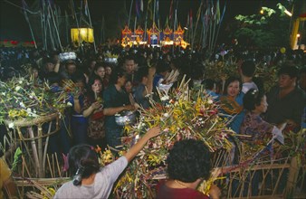 THAILAND, Chiang Mai, Wat Jedi Luang, Inthakhin Ceremony. People with offerings of flowers and joss