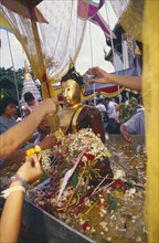 THAILAND, Chiang Mai, Wat Jedi Luang, Inthakhin Ceremony. Bathing Phra Fon Saen Ha Buddha statue