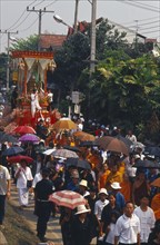 THAILAND, Chiang Mai, Revered monks funeral procession to cremation grounds with people pulling the