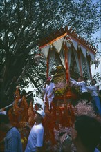THAILAND, Chiang Mai, Revered monks funeral procession to cremation grounds with people pulling the