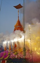 THAILAND, Chiang Mai, Revered monks funeral with smoking mythical elephant swan funeral pyre on the