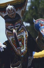 THAILAND, Loei Province, Dan Sai, Phi Ta Khon or Spirit Festival. Person wearing spirit mask