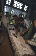 MYANMAR, Kachin State, Myitkyina, Jinghpaw funeral with the deceased in a coffin at the families