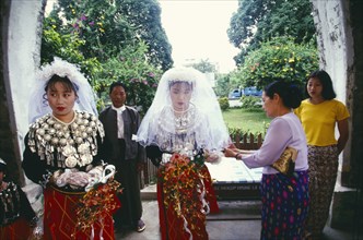 MYANMAR, Kachin State, Myitkyina, Jinghpaw wedding with Bride and bridesmaid entering the Geis