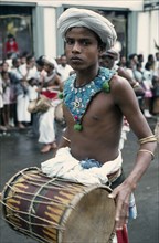SRI LANKA, Kandy, Esala Perahera festival parade drummer.