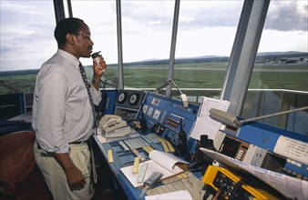TANZANIA, Dar es Salaam, Man using radio in airport control tower in Dar es Salaam airport.