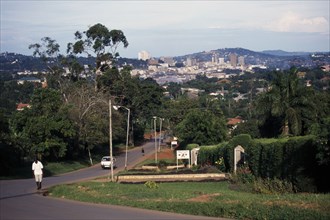 UGANDA, Kampala, Wealthy city suburbs with high rise city buildings beyond.