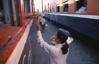 MYANMAR, Markets, Female vendor selling sweet corn to passengers on the Mandalay to Myitkyina train