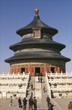 CHINA, Beijing, Temple of Heaven.  Hall of Prayer for Good Harvests and Chinese visitors posing for