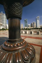 CHINA, Shanghai, People’s Square.  Circular paved area surrounded by skyscrapers with part view of
