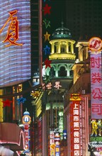 CHINA, Shanghai, Nanjing Road at night with illuminated neon signs.