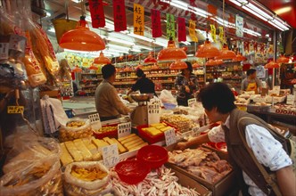 CHINA, Hong Kong, "Wanchi market interior with display of variety of food products, customers and