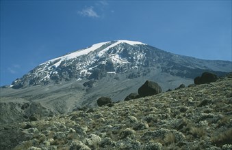 TANZANIA, Mount Kilimanjaro, Snow covered peak of Kilimanjaro with alpine desert plants in the