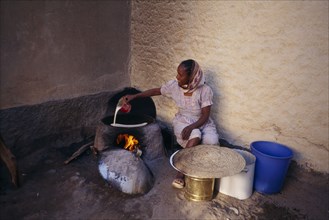 ERITREA, Keren, "Woman cooking injera, a type of sour, flat bread that accompanies most meals."