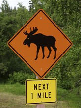 USA, Alaska, Road side sign warning of possibility of Moose in the road for the next 1 mile