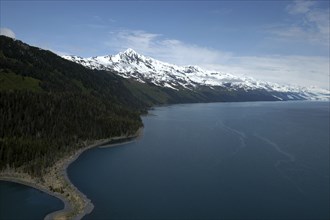 USA, Alaska, Prince William Sound, View along the coast toward snow capped mountain peaks