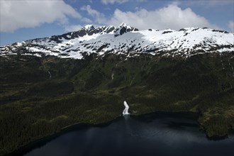 USA, Alaska, Prince William Sound, Aerial view over water and tree covered slopes leading toward