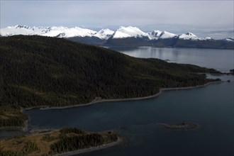 USA, Alaska, Prince William Sound, View along coastline toward snow capped mountain peaks