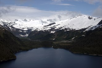 USA, Alaska, Prince William Sound, Aerial view over waters toward snow capped mountain peaks