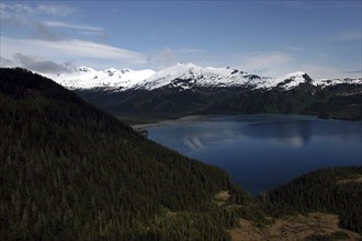 USA, Alaska, Prince William Sound, View over tree covered slopes and waters toward snow capped