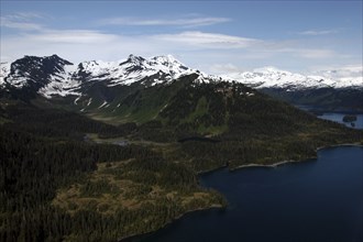 USA, Alaska, Prince William Sound, Aerial view over coastal landscape and snow capped mountain