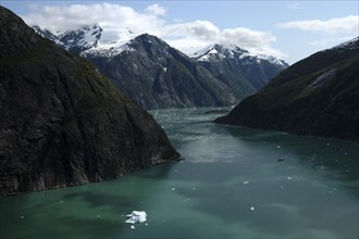 USA, Alaska, Tracy Arm Fjord, View over rocky cliff edged waterway toward mountain peaks