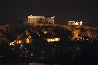 GREECE, Athens, View toward the hilltop Acropolis with the Parthenon and other ruins illuminated at