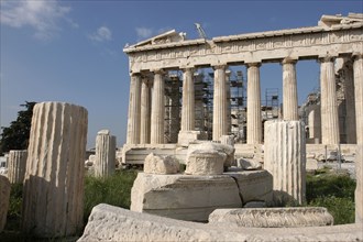 GREECE, Athens, Acropolis. View of the ruined Parthenon with smaller sections of columns in the