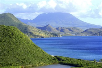 WEST INDIES, St Kitts, View over green hilly coastline and blue sea