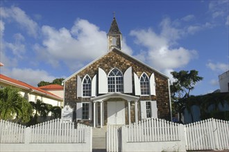 WEST INDIES, St Martin, Small brick church with white shuttered windows and surrounding picket