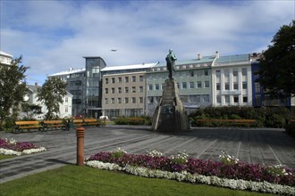 ICELAND, Reykjavik, View over the town Square with floral borders toward central statue and