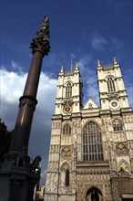 ENGLAND, London, Westminster Abbey west front towers and statue atop column in the foreground