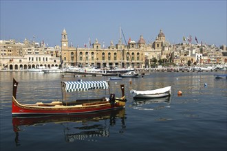 MALTA, Vittoriosa, View of moored boats in the harbour with the town beyond