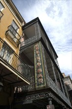 USA, Louisiana, New Orleans, French Quarter. Angled view looking up at ornate ironwork balcony of a