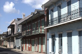 USA, Louisiana, New Orleans, French Quarter. View along row of pastel coloured buildings with