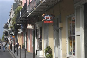USA, Louisiana, New Orleans, French Quarter. View along row of pastel coloured shops with ironwork
