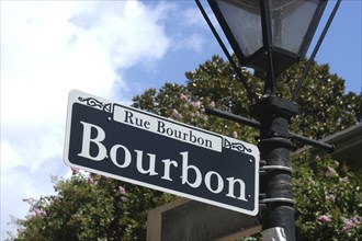 USA, Louisiana, New Orleans, French Quarter. Rue Bourbon street sign hanging on a lamp post