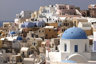 GREECE, Cyclades, Santorini, View over the towns architecture with blue domed buildings