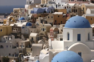 GREECE, Cyclades, Santorini, View over the towns architecture with blue domed buildings
